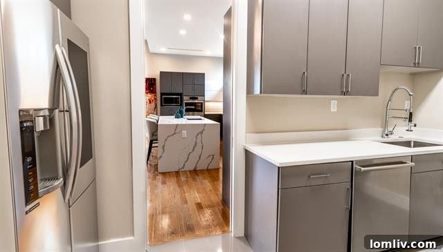 Stylish kitchen with marble countertops and contemporary light fixtures