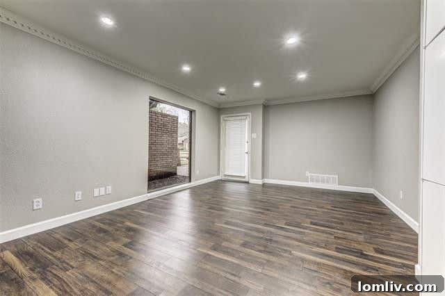 Modern eat-in kitchen with white cabinetry, granite countertops, and stainless steel appliances.