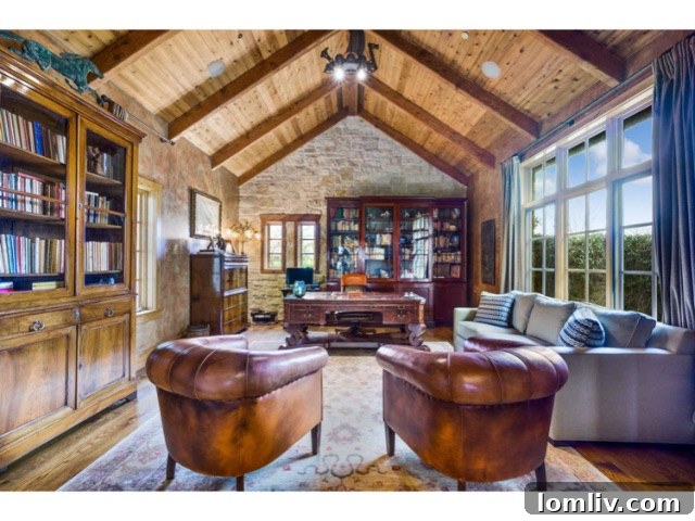 Luxurious master bedroom suite with a private seating area, elegant decor, and stunning lake views