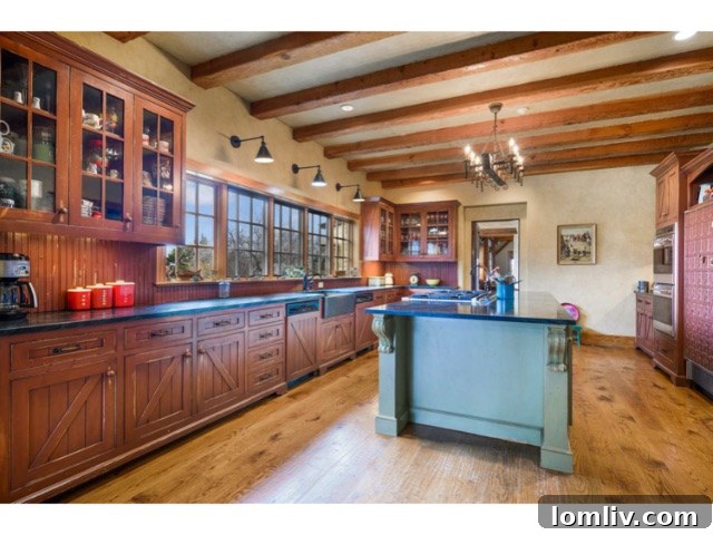 Inviting great room with soaring ceilings, a grand stone fireplace, and panoramic lake views