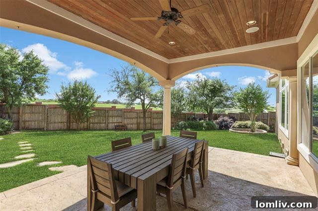 Contemporary media room with built-in storage and connection to an expansive patio