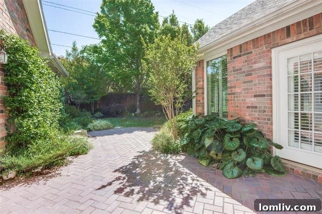 Secluded patio surrounded by vibrant flowerbeds and lush greenery, perfect for outdoor relaxation