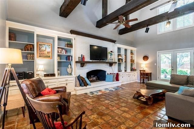 Spacious living room with vaulted ceilings, modern beams, and abundant natural light in a Dallas luxury home