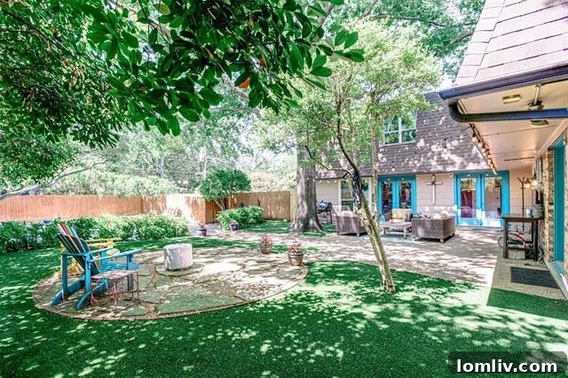 Modern kitchen with white cabinetry and island overlooking the living space in a Dallas luxury property