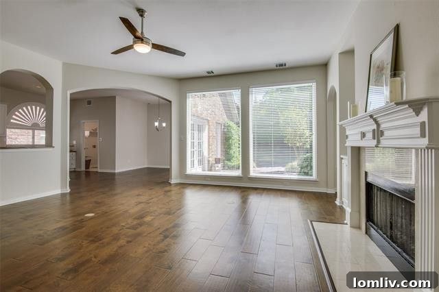 Bright dining room with hardwood floors and graceful columns in a charming Far North Dallas residence