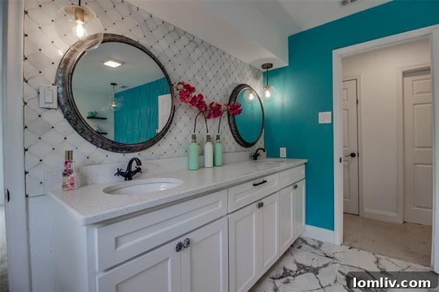 Stylish bathroom with modern vanity, sleek tiling, and updated fixtures, reflecting the recent remodel of the property