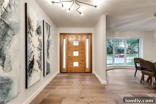 Spacious living room with natural light, showcasing beautiful wood floors and an inviting atmosphere in a Lake Highlands luxury home