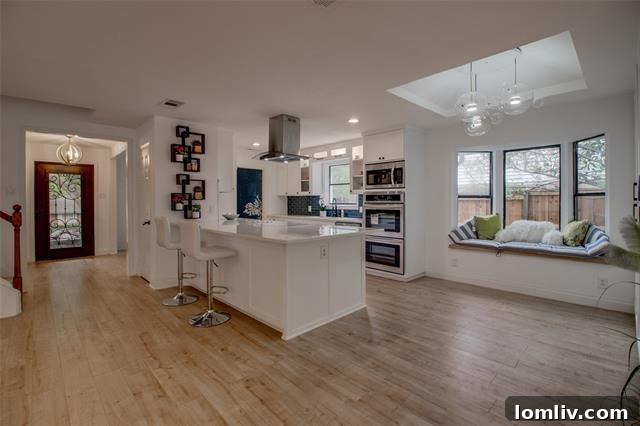 Bright living area with expansive panoramic windows offering views of the backyard pool, enhancing the open concept of this Lake Highlands home