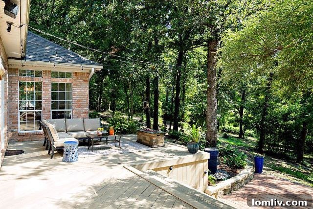 Bright master bedroom with wood floors and French doors opening to the serene outdoor deck.