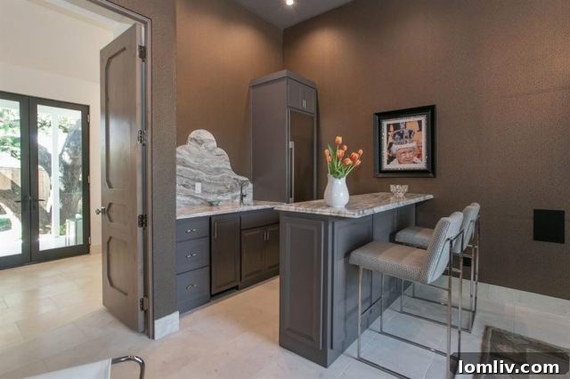 Inviting media room featuring Schumacher wallpaper and a full bar