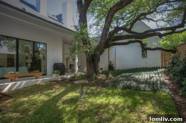 Chic outdoor living area with limestone paving, fireplace, and grill