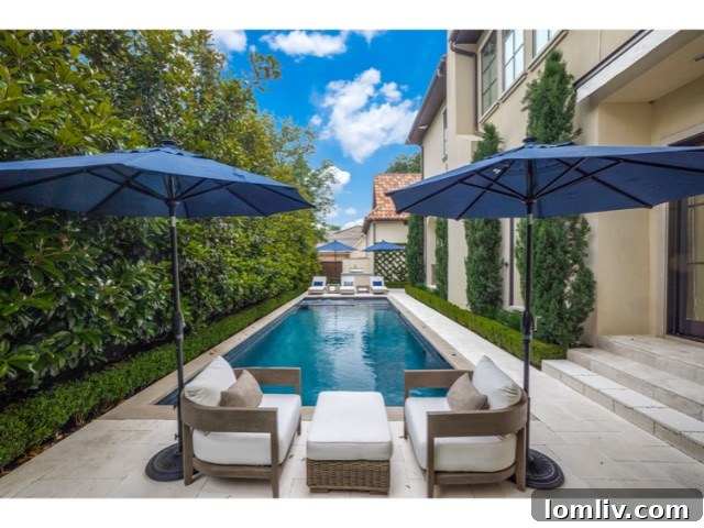 Full view of the magnificent pool area and back facade of the Mediterranean mansion