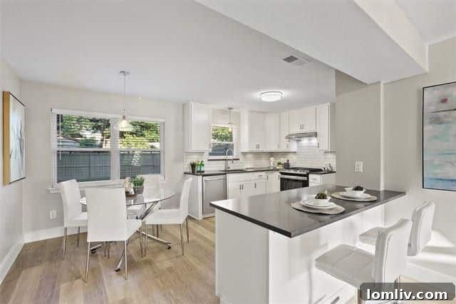 Elegant dining nook adjacent to the open kitchen with modern finishes, stylish lighting, and abundant natural light from large windows.