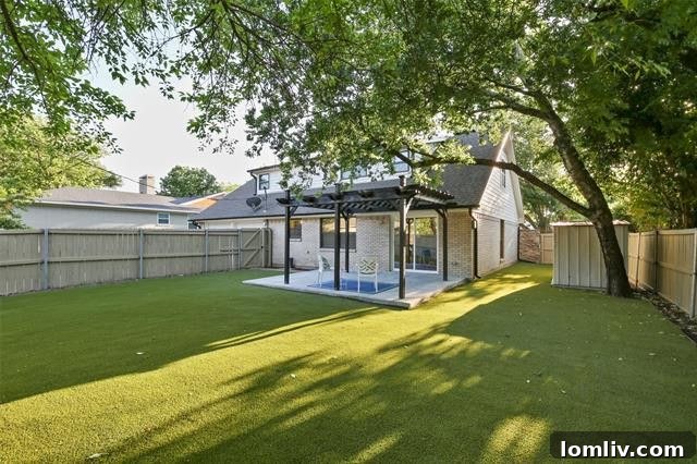 Inviting backyard of 2606 Beechmont Drive with irrigated turf lawn, a comfortable shaded pergola, and mature trees providing privacy.