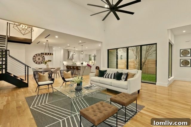 Gourmet kitchen with sleek design, island, and dining area in a luxury Inwood Park home.