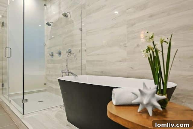 Modern living room with fireplace and seating, showcasing the open concept in a Dallas luxury home.