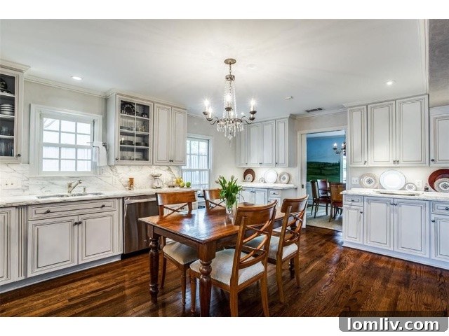A beautifully remodeled kitchen, featuring white marble counters, custom cabinetry, and a gas range