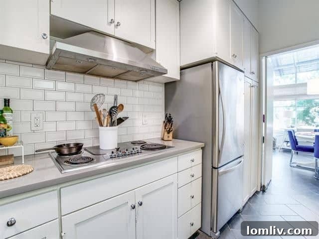 Elevate Your Lifestyle in University Park 9 Modern Kitchen with Subway Tile Backsplash, White Cabinetry, Stainless Steel Appliances