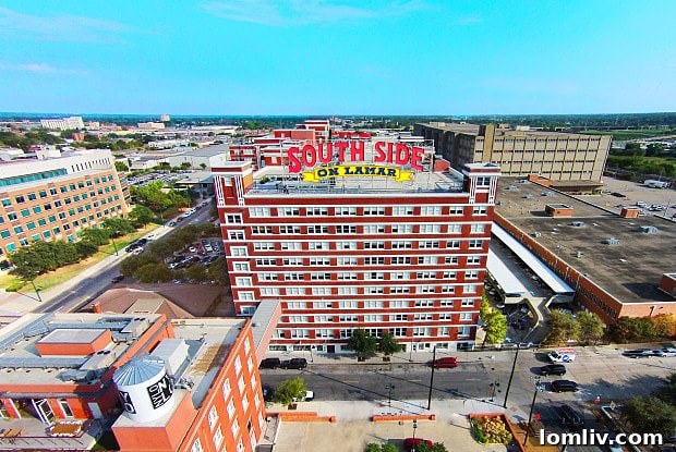 The distinctive facade of the South Side on Lamar building, showcasing its historical brickwork