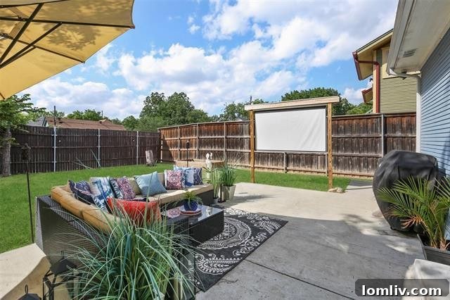 Lush fenced backyard with mature trees, a large patio, and a storage shed, featuring a DIY projector screen for outdoor movies