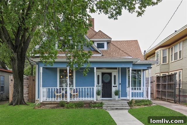 Charming blue exterior of a traditional Craftsman-style home in Old East Dallas with a welcoming front porch