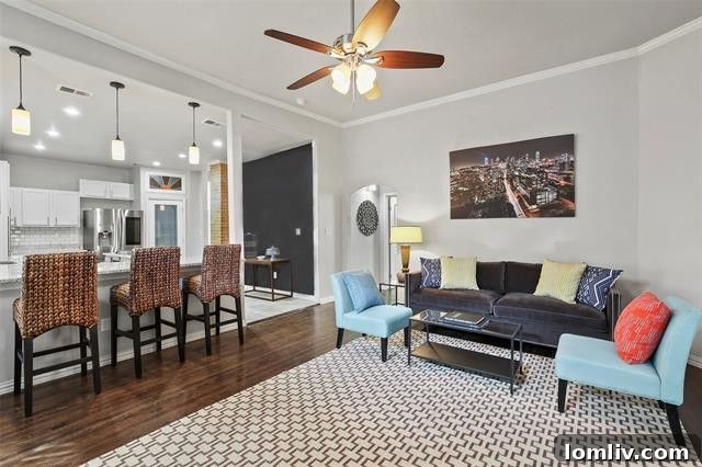 Elegant elongated foyer with original hardwood floors and period accents, setting a welcoming tone
