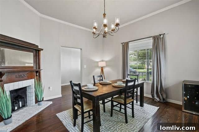 Formal dining room featuring a classic fireplace and original hardwood floors, ideal for entertaining