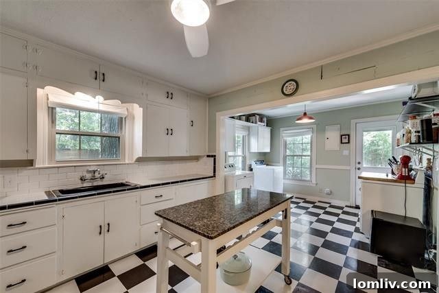 Vintage-inspired kitchen with subway tile and checkerboard floor