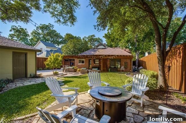 The American Dream Thrives in Dallas 8 Beautiful backyard with pergola and stone patio in Dallas Tudor