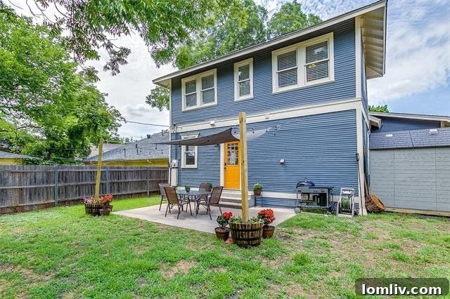 Spacious backyard with patio and covered parking behind electric gate
