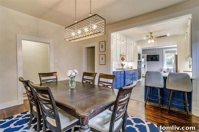 Elegant dining room leading to a modern kitchen in a historic Fort Worth bungalow