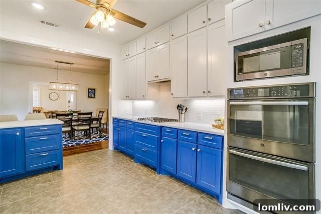 Spacious modern kitchen with blue cabinets, quartz counters, and high-end appliances