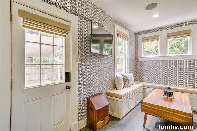 Cozy mudroom with patterned wallpaper, integrated laundry, and powder room