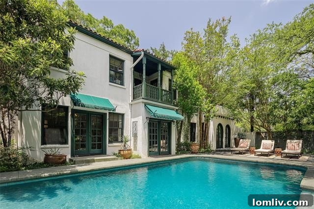 Beautifully landscaped entrance with Spanish architectural elements