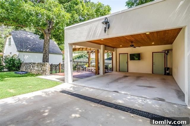 Charming exterior with rock masonry walls and lush landscaping in Berkley Place