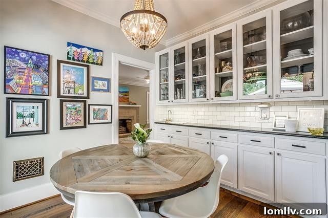 Elegant white-on-white kitchen with a breakfast bar in the Berkley Place home