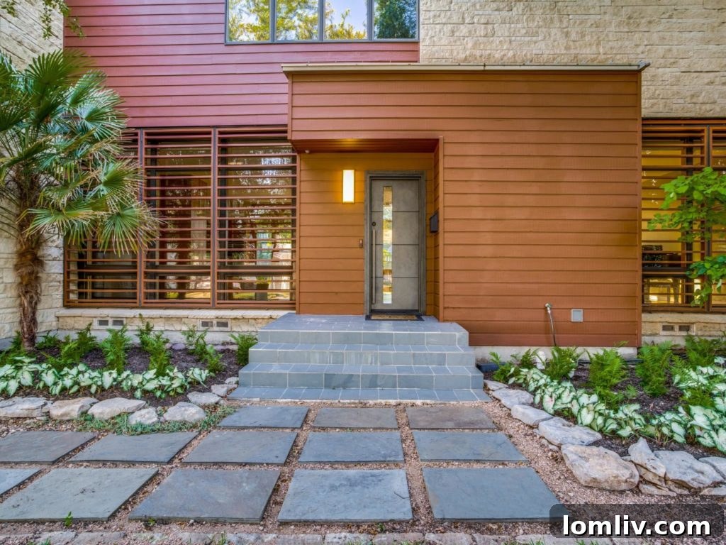Expansive backyard of 4411 Pomona featuring a large flagstone patio and mature trees