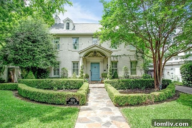 Elegant Fort Worth home exterior with manicured lawn and semicircular hedges