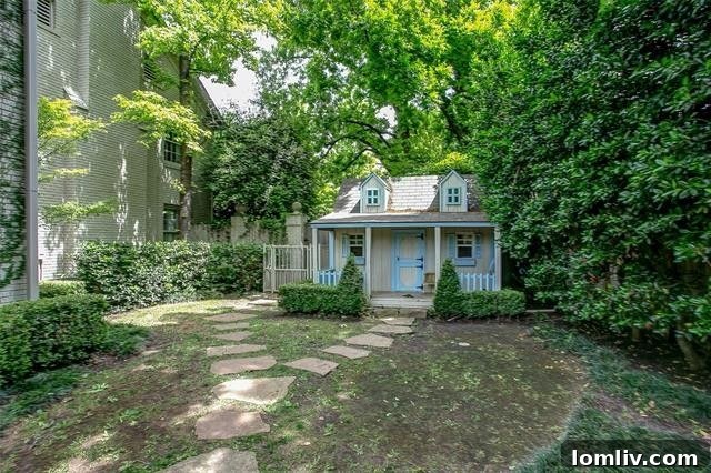 Stunning backyard oasis with an organically contoured pool, cabana, and leafy arbors