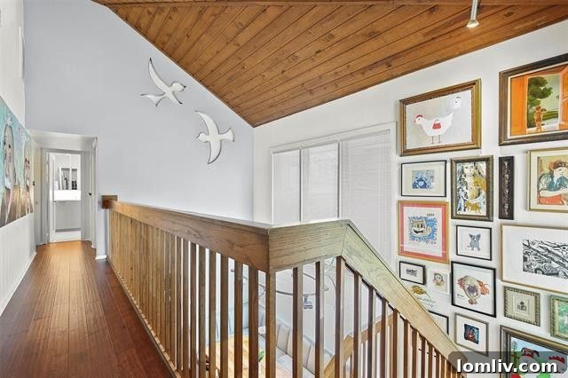 Custom stainless steel bird windows integrated into a vaulted ceiling, allowing light and creating an artistic glow.