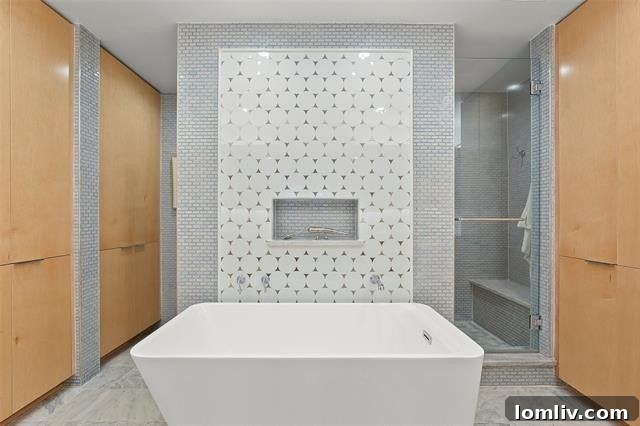 The uniquely designed bathroom, featuring custom white tile and stainless steel inserts, a favorite part of the home.