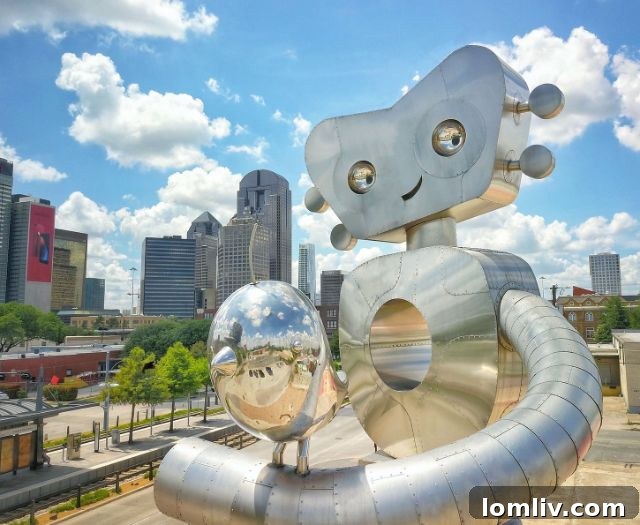The Traveling Man walking tall, accompanied by a Bird sculpture by Brad Oldham, a landmark in Deep Ellum.