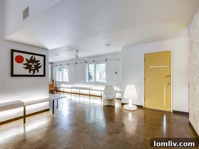 Leading Lighting Designer Tully Weiss' Lakewood Home Hits the Market 4 Spacious and minimalist living area with concrete floors and art walls