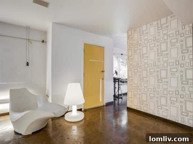 Leading Lighting Designer Tully Weiss' Lakewood Home Hits the Market 8 Light-filled interior showcasing concrete floors and abundant art walls