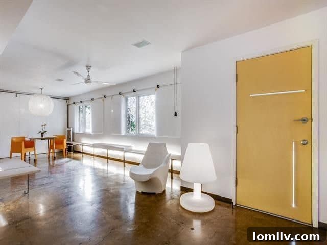 Leading Lighting Designer Tully Weiss' Lakewood Home Hits the Market 10 Elegant lighting fixture illuminating a minimalist living space