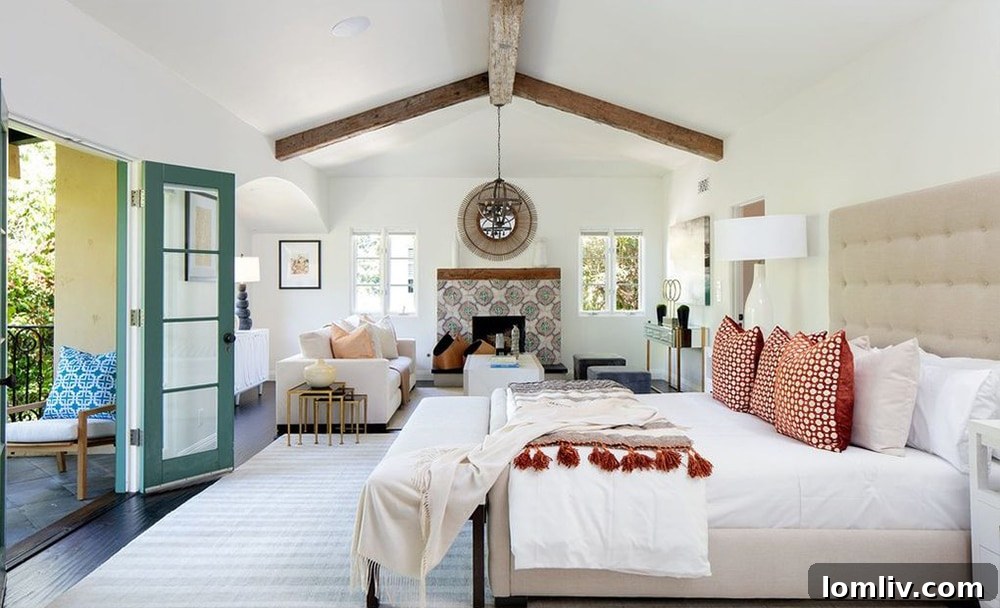 Elegant owner's bedroom suite with fireplace and sitting area in Geena Davis's Pacific Palisades house