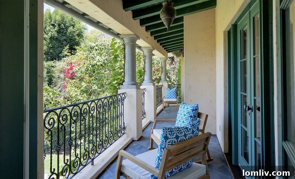 Private covered balcony off the owner's suite, overlooking the lush garden
