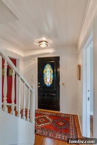 Welcoming central hall entry with hardwood floors