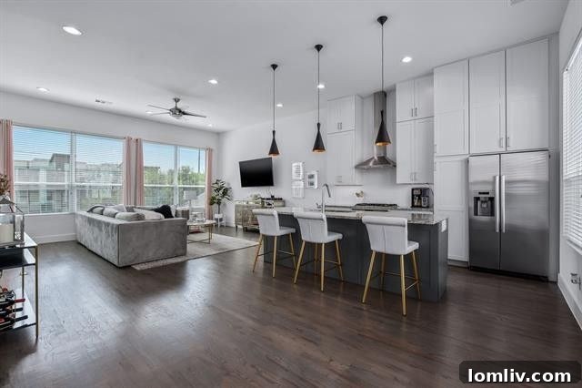 Open-concept living area with high ceilings and designer lighting