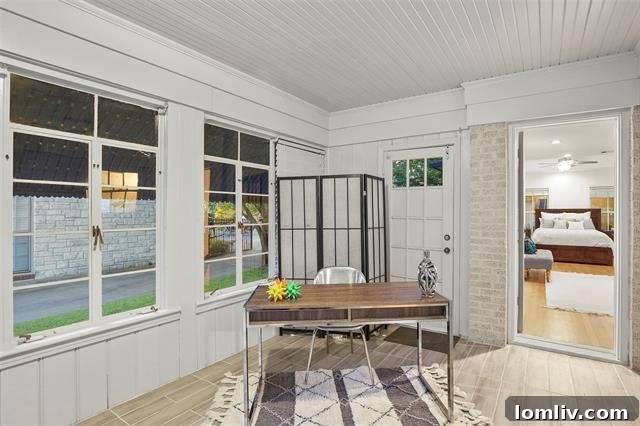 Home office with beadboard ceiling and modern flooring, overlooking the front yard